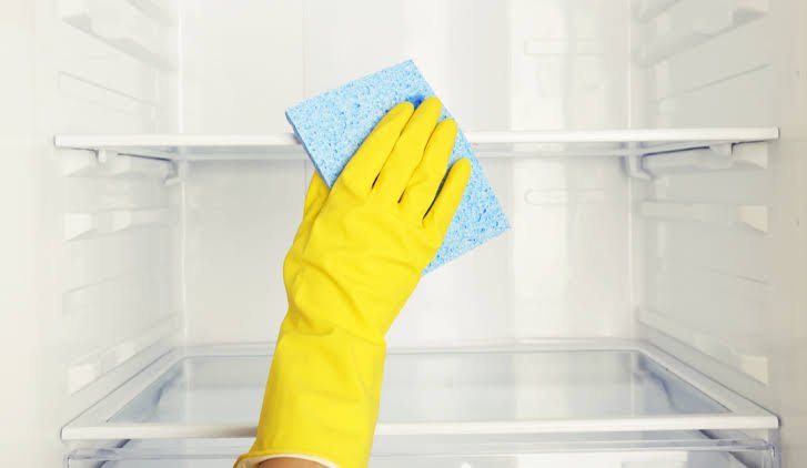 Emptying and prepping the refrigerator for cleaning